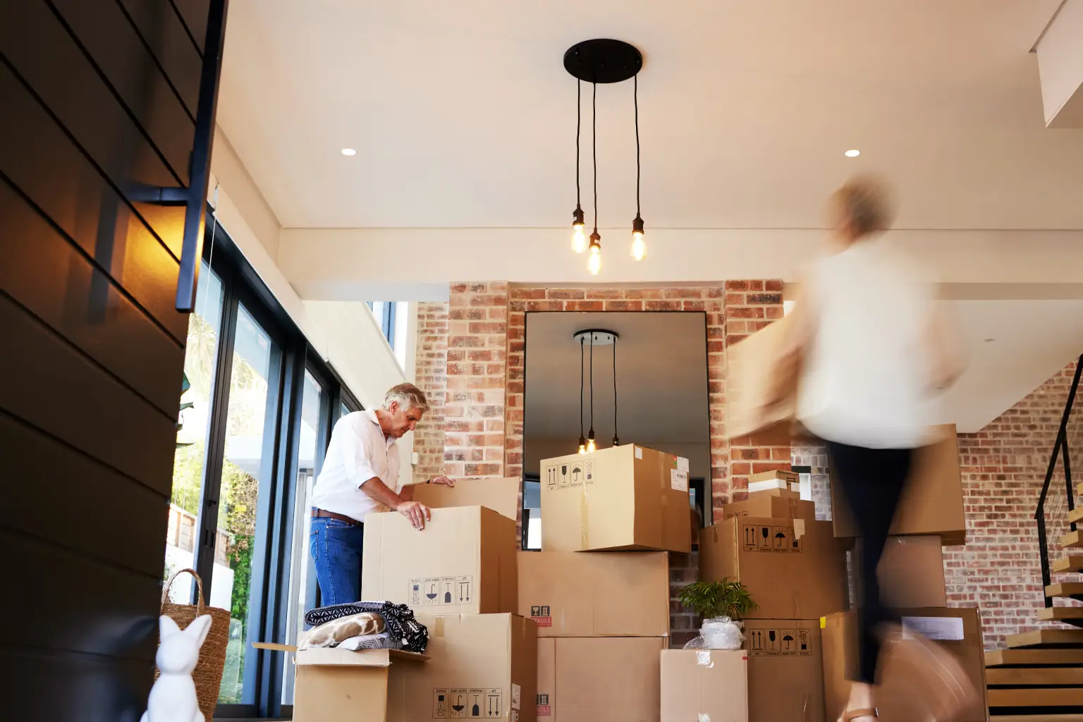 People packing moving boxes inside a home