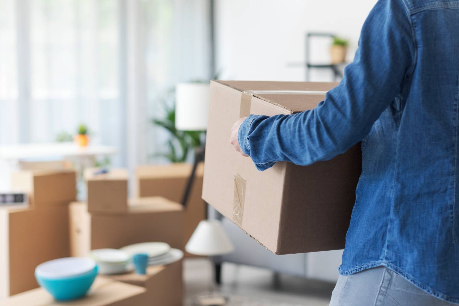 Person carrying a moving box